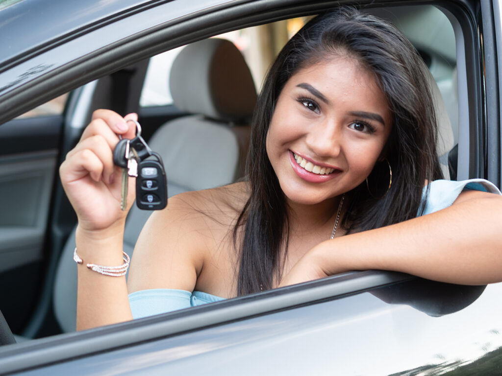 Happy Customer Getting Keys to New Car at Car Dealership