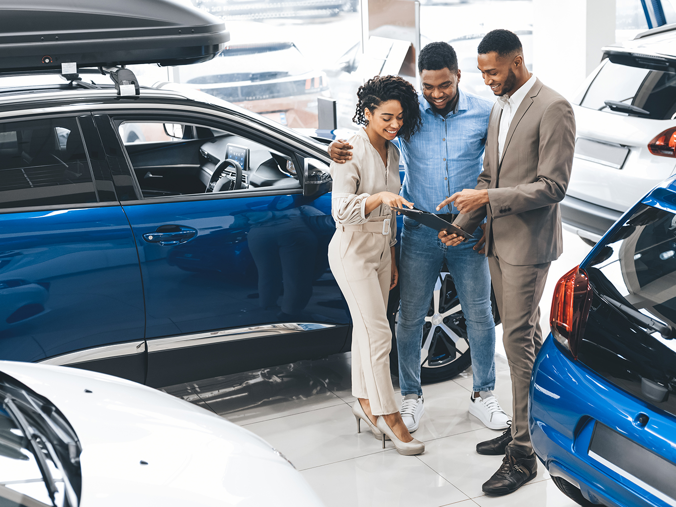 Our Trusted Dealers and Lenders Help Customers Find Their Dream Cars Happy customers standing in front of their new car with their dealer