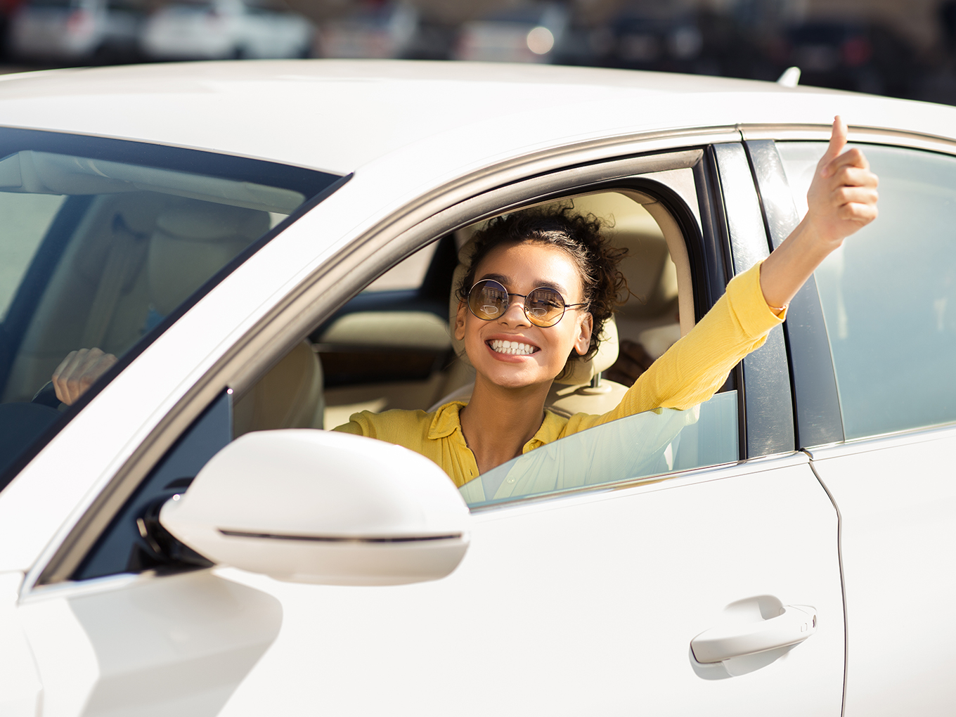 Experience the joy of car ownership with Approval Heroes Happy female customer driving her new car purchased through Approval Heroes