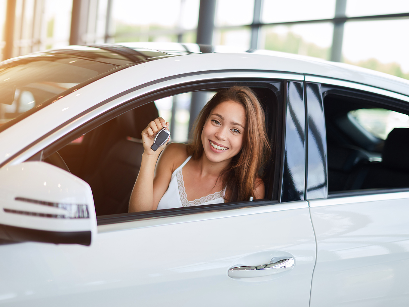 Satisfied Customer Driving Her New Car Thanks to Approval Heroes Happy female customer driving her new car, feeling satisfied with her purchase