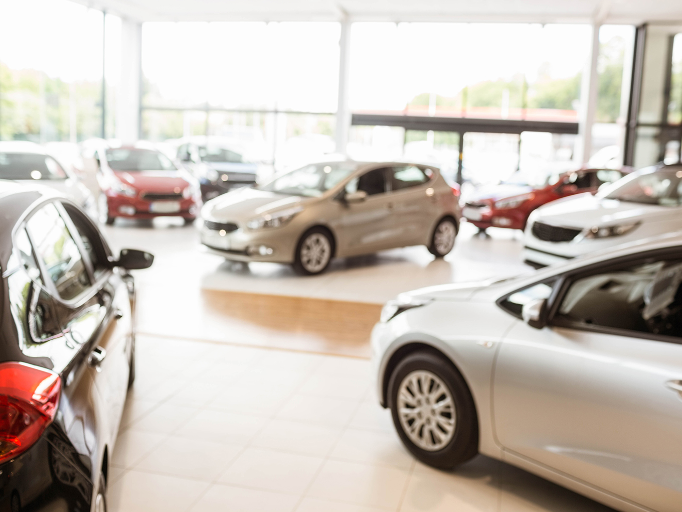 Inside of a Car Dealer Showroom A spacious and modern car dealership showroom with a wide variety of vehicles on display