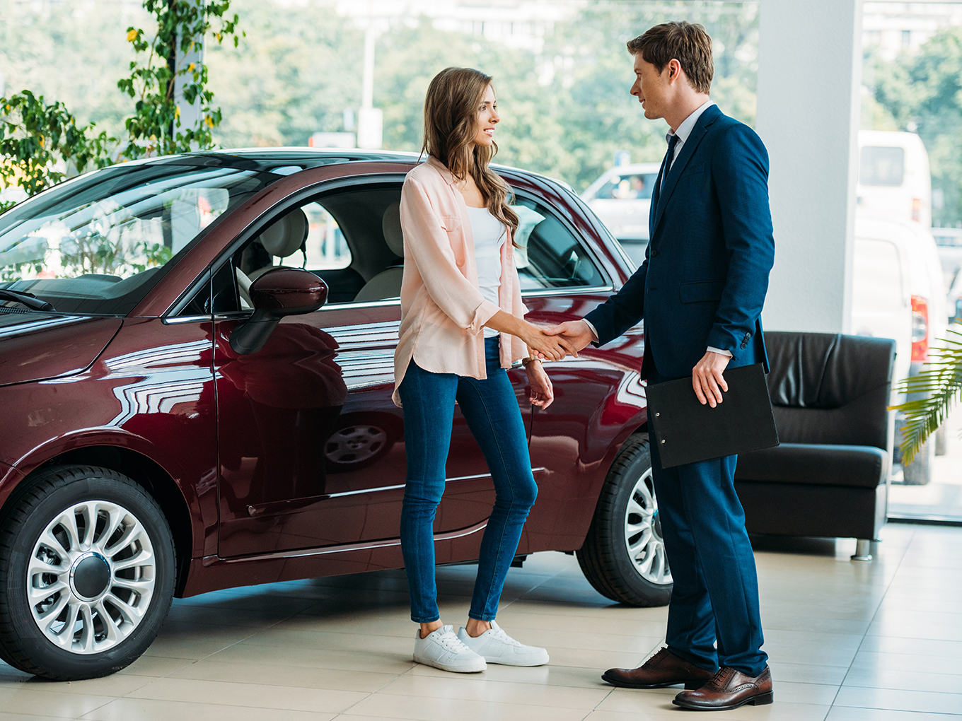 Approval Heroes - Partnering with Trusted Dealers and Lenders for a Stress-Free Car Shopping Experience A smiling customer shaking hands with a representative of a trusted car dealer or lender